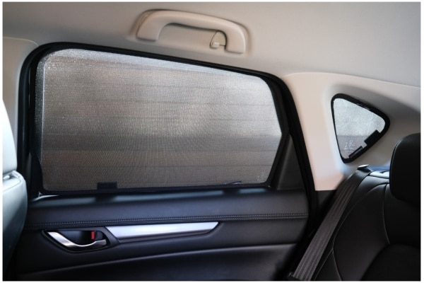 Interior view of a Mazda CX-5 2nd Generation rear window fitted with Snap Shades sunshades for enhanced UV protection.